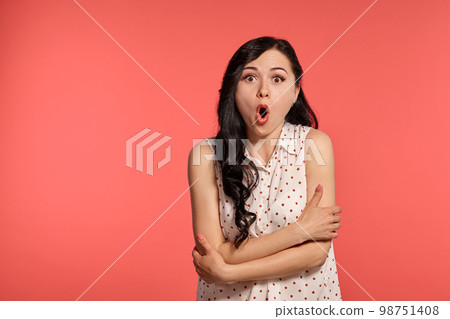 Studio shot of a lovely girl teenager posing over a pink background. 98751408