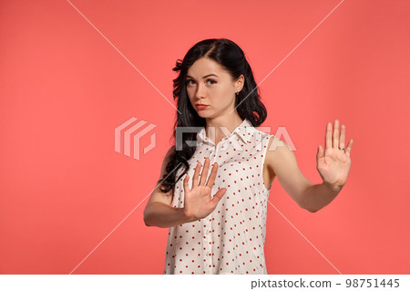 Studio shot of a lovely girl teenager posing over a pink background. 98751445