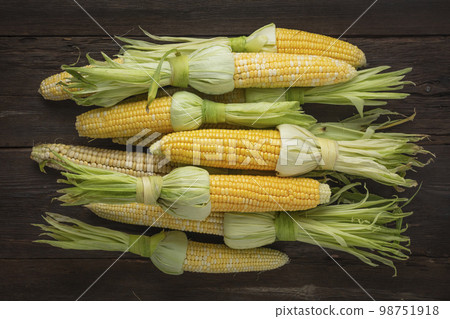 Heap of fresh raw corn on the cob Heap of fresh raw corn on the cob 98751918