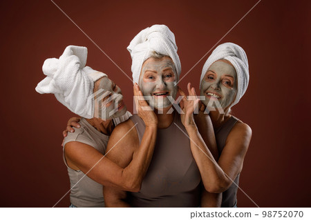 Portrait of happy senior friends with face-mask, selfcare and skin routine concept. 98752070