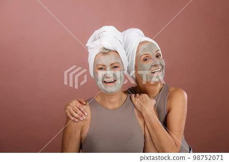 Portrait of happy senior friends with face-mask, selfcare and skin routine concept. 98752071