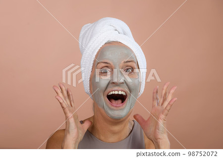 Portrait of excited senior woman with face-mask, selfcare and skin routine concept. 98752072