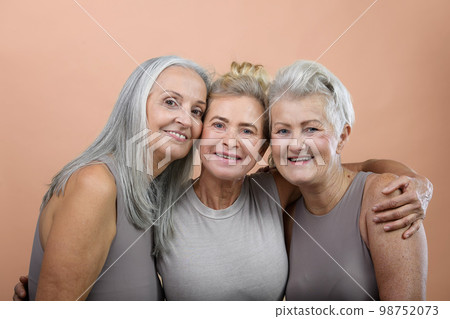 Portrait of happy three senior friends in studio. 98752073