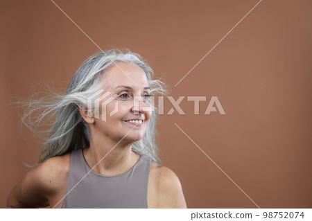 Portrait of smiling senior woman in studio. Portrait of smiling senior woman in studio. 98752074