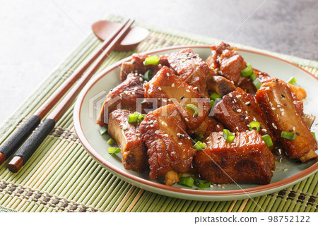 Chinese sweet and sour ribs with green onion and sesame close-up in a plate. Horizontal 98752122