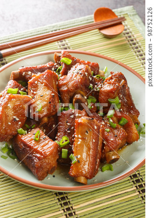Sweet and Sour Rib Tang Cu Pai Gu is a quite popular dish in China close-up in a plate. Vertical Sweet and Sour Rib Tang Cu Pai Gu is a quite popular dish in China close-up in a plate. Vertical 98752126