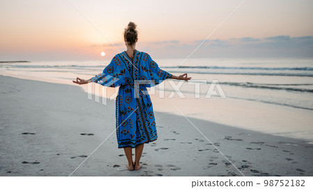 Young woman enjoying time at sea, meditating. Young woman enjoying time at sea, meditating. 98752182