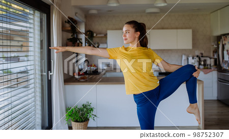 Young woman doing an exercises at home. 98752307