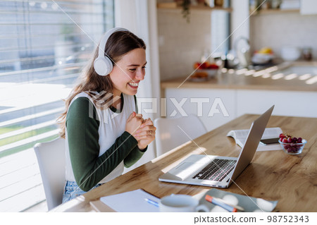 Young woman having homeoffice in her apartment. 98752343