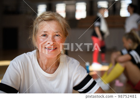 Happy senior woman before basketball match in gym. 98752481