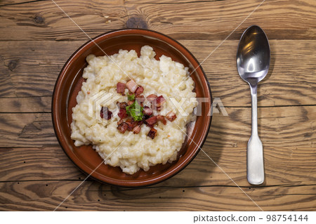 Slovakian halusky served with sheep cheese and roasted bacon Slovakian halusky served with sheep cheese and roasted bacon 98754144