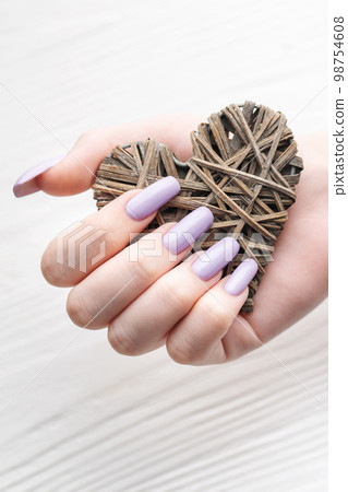 Girl's hands with delicate purple manicure and decoratine heart 98754608