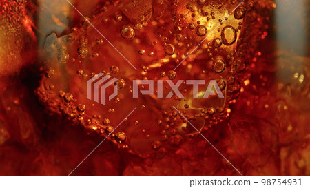 Detail of cola with ice cubes in glass. Detail of cola with ice cubes in glass. 98754931
