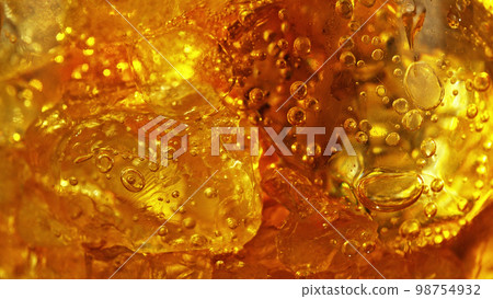 Detail of cola with ice cubes in glass. Detail of cola with ice cubes in glass. 98754932