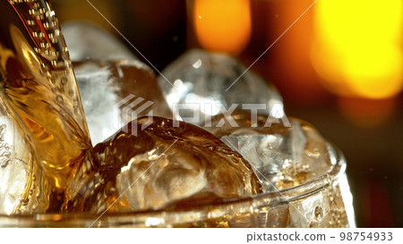 Super macro shot of pouring cola drink into glass. Super macro shot of pouring cola drink into glass. 98754933