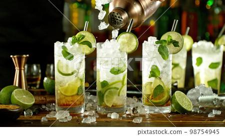 Preparation of mojito drinks on bar counter. Preparation of mojito drinks on bar counter. 98754945