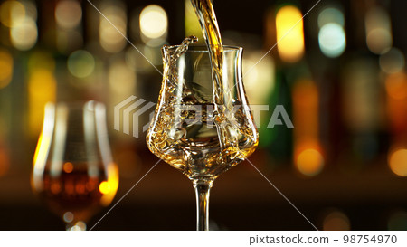 Detail of pouring rum into glass. 98754970