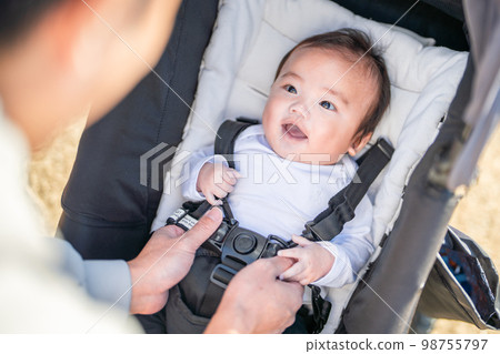 A baby who rides in a stroller at the destination and has his dad wear a seat belt A baby who rides in a stroller at the destination and has his dad wear a seat belt 98755797