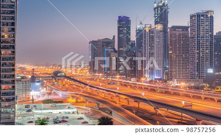 Dubai Marina skyscrapers and Sheikh Zayed road with metro railway aerial day to night , United Arab Emirates 98757256