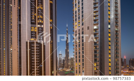 Tallest skyscrapers in downtown dubai located on bouleward street near shopping mall aerial day to night . Tallest skyscrapers in downtown dubai located on bouleward street near shopping mall aerial day to night . 98757383