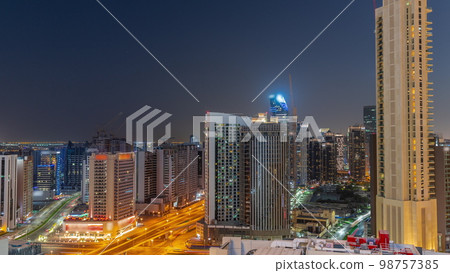 Skyscrapers at the Business Bay in Dubai aerial day to night , United Arab Emirates Skyscrapers at the Business Bay in Dubai aerial day to night , United Arab Emirates 98757385
