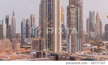 Panorama of the tall buildings around Sheikh Zayed Road and DIFC district aerial night to day in Dubai Panorama of the tall buildings around Sheikh Zayed Road and DIFC district aerial night to day in Dubai 98757387