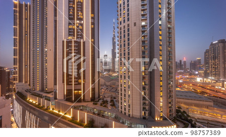 Tallest skyscrapers in downtown dubai located on bouleward street near shopping mall aerial day to night . Tallest skyscrapers in downtown dubai located on bouleward street near shopping mall aerial day to night . 98757389