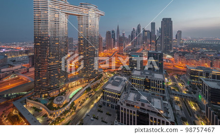 Futuristic Dubai Downtown and finansial district skyline aerial night to day . 98757467