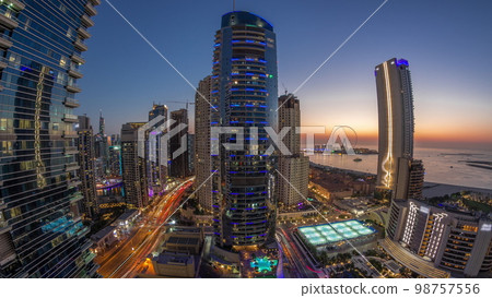 Panorama of the Dubai Marina and JBR area and the famous Ferris Wheel aerial day to night Panorama of the Dubai Marina and JBR area and the famous Ferris Wheel aerial day to night 98757556