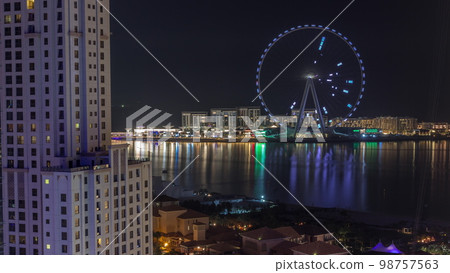 Bluewaters island with modern architecture and ferris wheel aerial night . 98757563