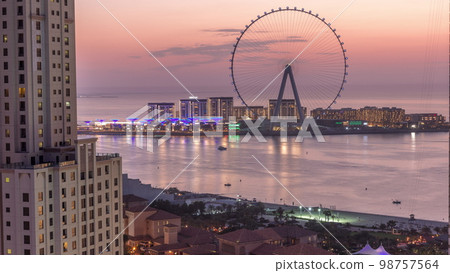 Bluewaters island with modern architecture and ferris wheel aerial day to night . 98757564