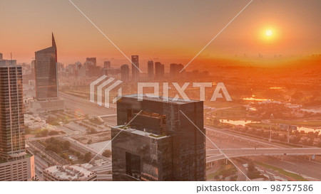 Sunrise over media city and al barsha heights district area night to day from Dubai marina. Sunrise over media city and al barsha heights district area night to day from Dubai marina. 98757586