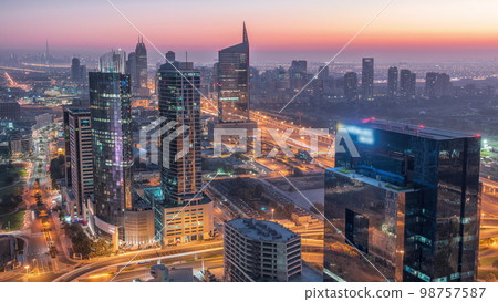 Aerial view of media city and al barsha heights district area night to day from Dubai marina. Aerial view of media city and al barsha heights district area night to day from Dubai marina. 98757587