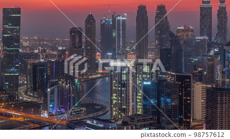 Skyline with modern architecture of Dubai business bay towers day to night . Aerial view Skyline with modern architecture of Dubai business bay towers day to night . Aerial view 98757612