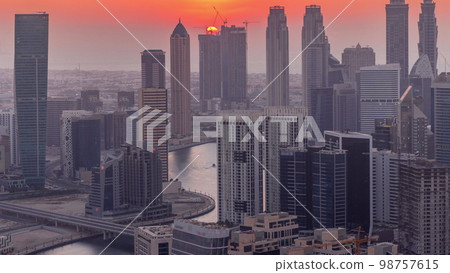 Skyline with modern architecture of Dubai business bay towers at sunset . Aerial view Skyline with modern architecture of Dubai business bay towers at sunset . Aerial view 98757615