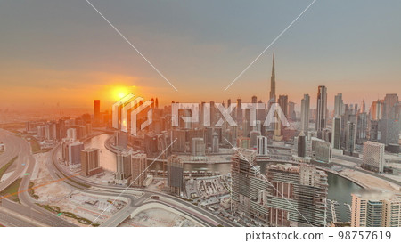 Skyline with modern architecture of Dubai business bay towers at sunset . Aerial view Skyline with modern architecture of Dubai business bay towers at sunset . Aerial view 98757619