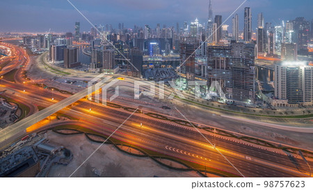 Panoramic skyline of Dubai with business bay and downtown district night to day . Panoramic skyline of Dubai with business bay and downtown district night to day . 98757623