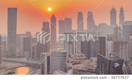 Skyline with modern architecture of Dubai business bay towers at sunset . Aerial view Skyline with modern architecture of Dubai business bay towers at sunset . Aerial view 98757637