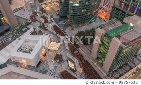 Dubai international financial center skyscrapers aerial night to day . 98757638