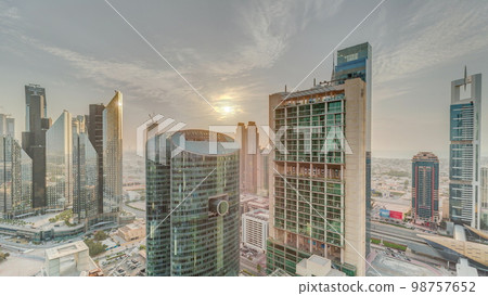 Sunset over Dubai international financial center skyscrapers aerial . 98757652