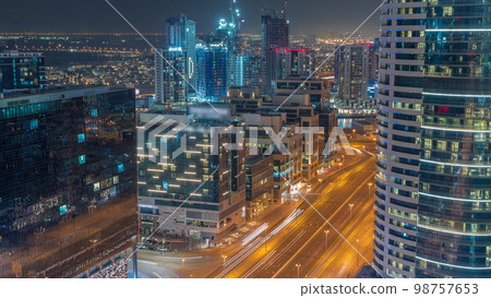 Dubai's business bay towers aerial night . Rooftop view of some skyscrapers 98757653