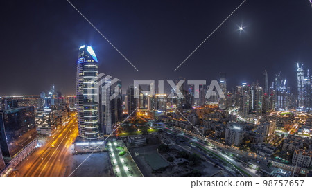 Dubai's business bay towers aerial all night . Rooftop view of some skyscrapers 98757657