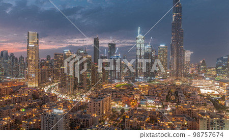 Dubai Downtown day to night transition with tallest skyscraper and other towers Dubai Downtown day to night transition with tallest skyscraper and other towers 98757674