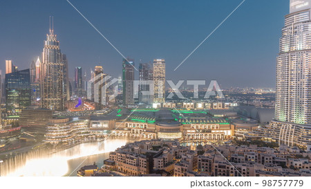 Aerial view of Dubai International Financial Centre district day to night 98757779