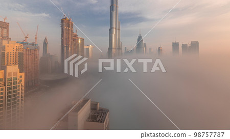 Aerial view of Dubai city early morning during fog . 98757787