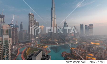 Aerial view of Dubai city early morning during fog night to day . 98757788