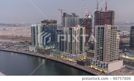 Towers at the Business Bay aerial day to night in Dubai, United Arab Emirates Towers at the Business Bay aerial day to night in Dubai, United Arab Emirates 98757800