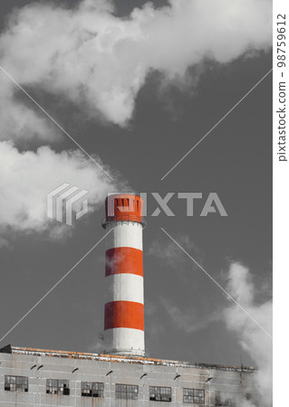 Pollution of the environment, ecology and air. Withdrawal of combustion products of soot, smoke and gases from the pipe of an industrial plant into the atmosphere against the background of a gray sky Pollution of the environment, ecology and air. Withdrawal of combustion products of soot, smoke and gases from the pipe of an industrial plant into the atmosphere against the background of a gray sky 98759612