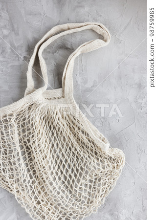 Reusable shopping mesh bag on gray background. Zero waste, no plastic, eco friendly shopping, recycling concept. Flat lay, close up 98759985