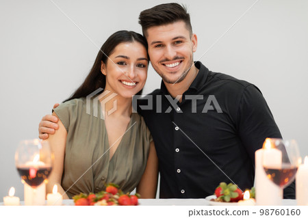Cheerful beautiful lovers embracing while celebrating valentine day 98760160